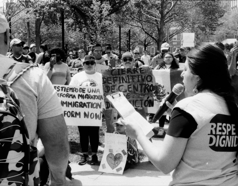A person speaking at an immigration protest