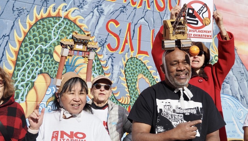 a group of protesters gathered in Philadelphia's Chinatown holding 'no arena' posters