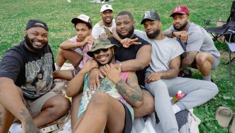 a group of people posing for a photo at an outdoor movie screening