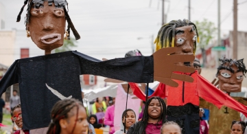 children hold puppets and march at Spiral Q 2024 Blankenburg Parade