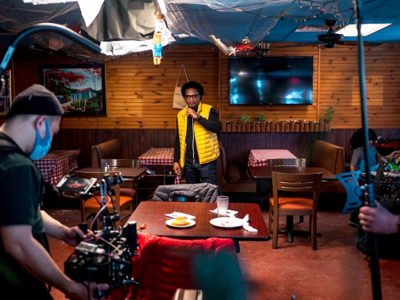 A film crew sets up for filming inside a restaurant