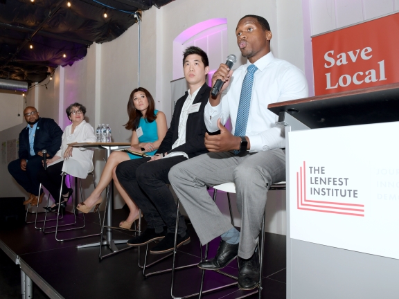 a seated man speaking during a five person panel at the Lenfest Institute