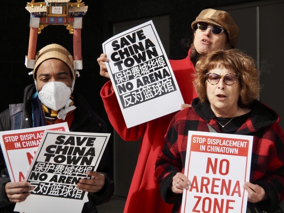 three protesters holding signs that read "Save Chinatown" and "No Arena"
