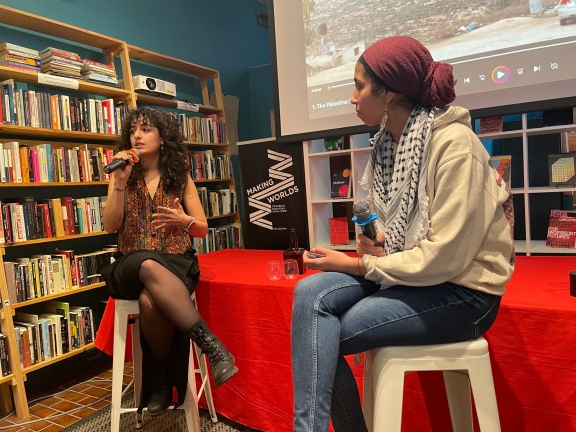 a post film screening interview with two people sitting on chairs at the front of a room