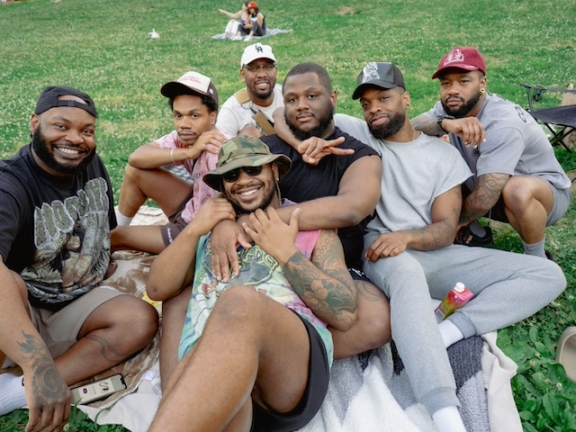 a group of people posing for a photo at an outdoor movie screening