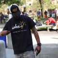 A person looking down and holding their IDEA Center for the Arts t-shirt