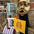 A Spiral Q puppet show display that reads 'our community is not for sale'