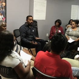 people gathered in a circle for a meeting